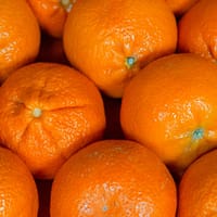 Bright closeup of fresh juicy oranges showcasing vibrant citrus texture and color.